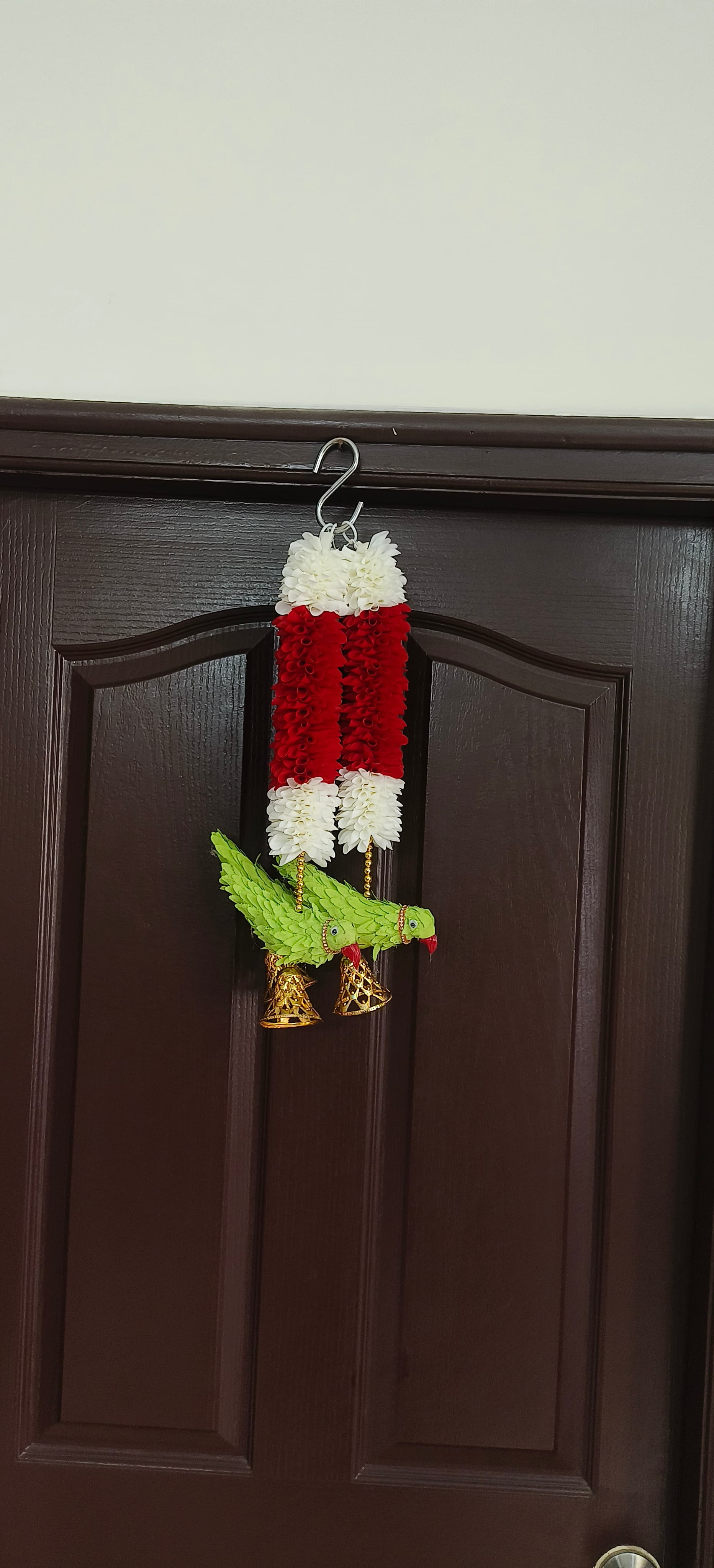 Fabric garlands with parrot and bell hangings.